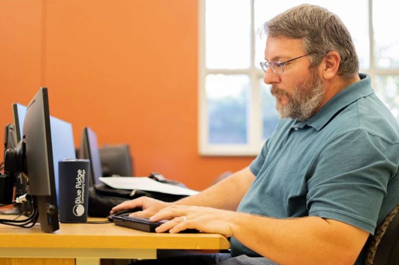 Man works on laptop 