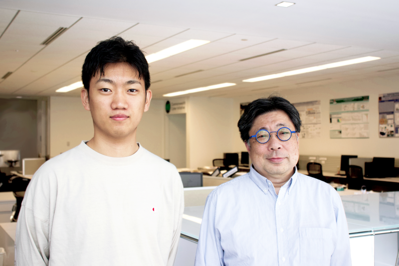 Virginia Tech grad student Kigen Fukuda (left) standing near advisor Shin’ichiro Matsuo, CCI research professor and blockchain expert. Photo by Kate Horwich for CCI.