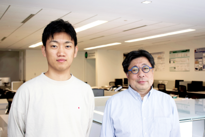 Virginia Tech grad student Kigen Fukuda (left) standing near advisor Shin’ichiro Matsuo, CCI research professor and blockchain expert. Photo by Kate Horwich for CCI.