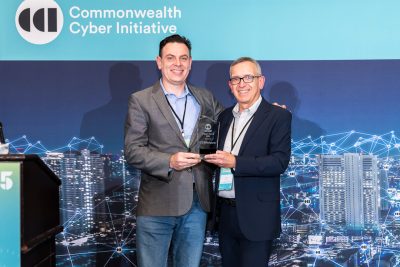 CTEWorkforce CEO Bobby Keener accepts the CCI Impact Award from CCI Executive Director Luiz DaSilva at the CCI Symposium 2025.