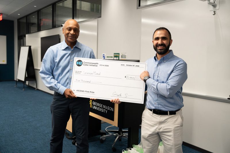 Timothy Jones (left) of TBJ Investments presents Khaled Khasawneh of George Mason University with the $5,000 ASCEND pitch prize for SecureMind.