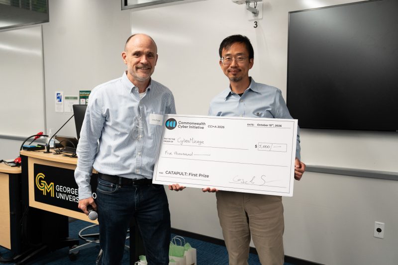 John Funge (left) of Datatribe presents Mingkui Wei of George Mason University with the $5,000 CATAPUT pitch prize for CyberMirage.