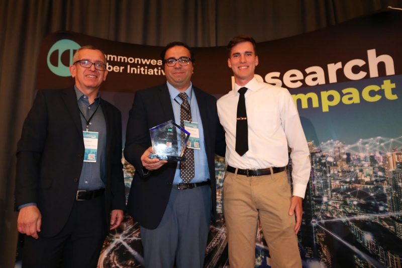 Luis DaSilva, executive director of CCI, presents award to   Sherif Abdelhamid and Kolby Quigg