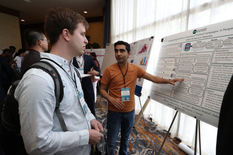 Student discusses his research at the 2023 CCI Symposium poster session.