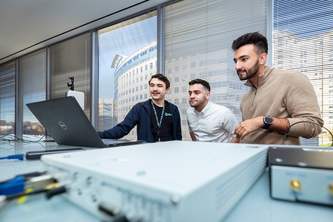 Team of researchers looking at laptop and equipment.