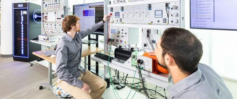 Two researchers work on computer equipment