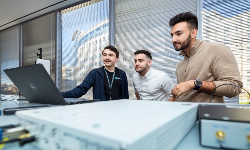Team of researchers looking at laptop and equipment.