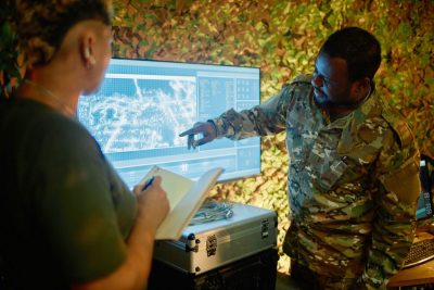 Military people discuss strategy on computer screen