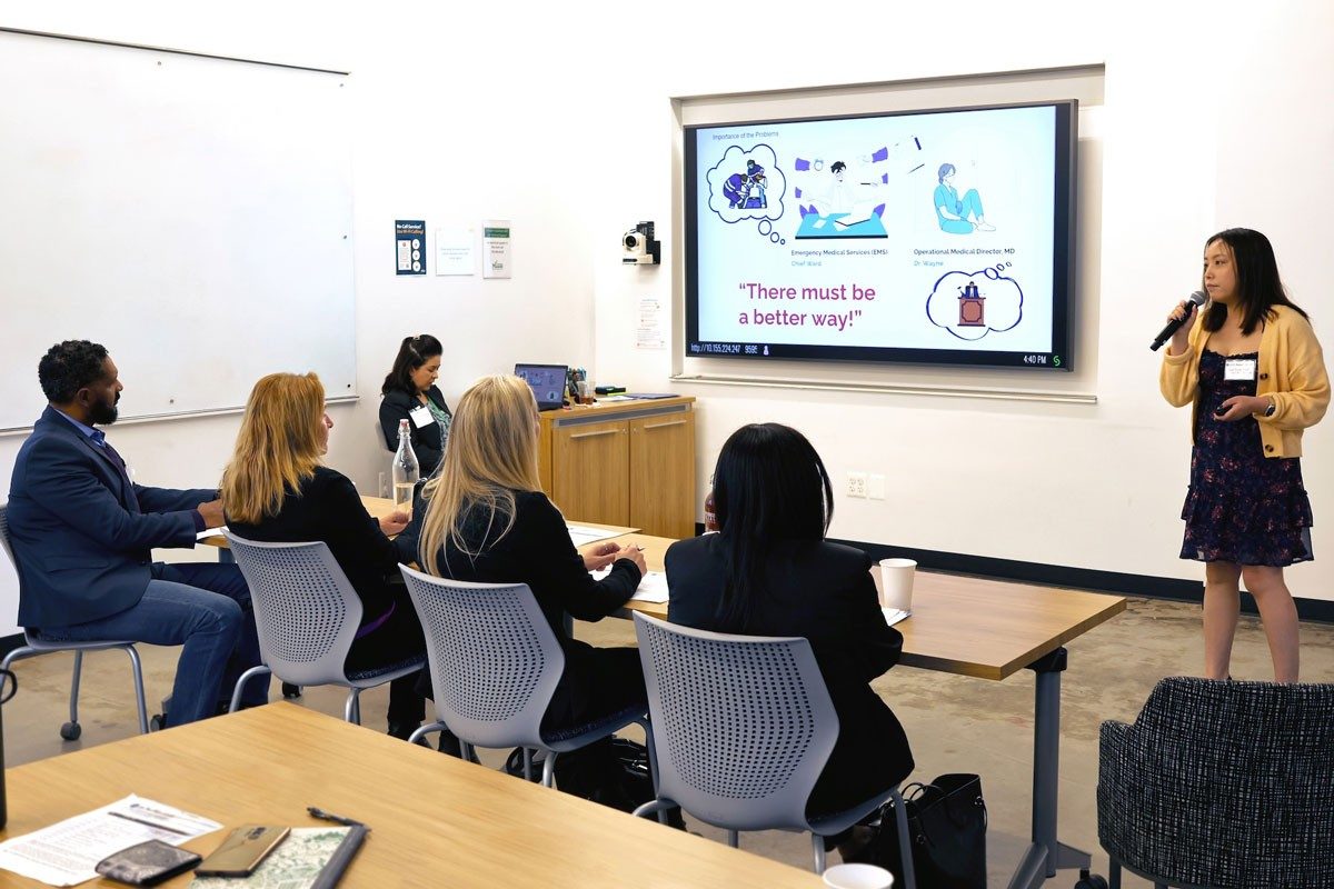 Woman present information on screen to investors