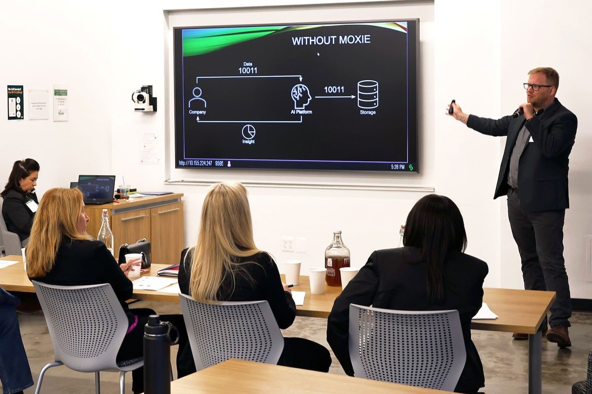 Man presents information on screen to audience