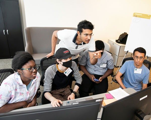 Students look at computer screens at CCI Cyber Camp