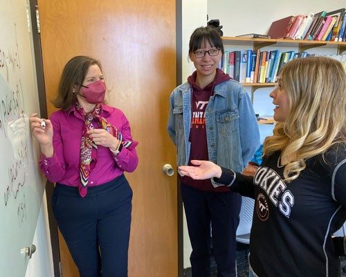 Teacher and students discuss mathematical algorithms