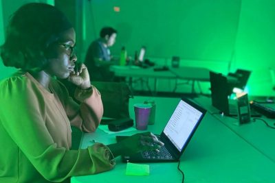 young woman works on laptop 