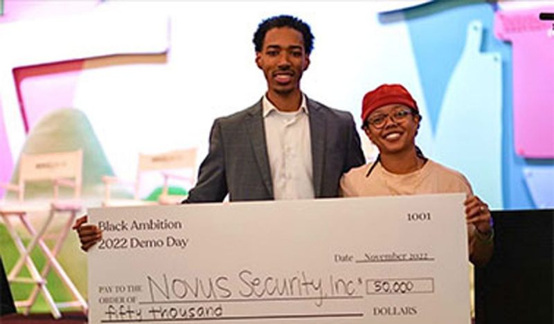 Emanuel Perez and Dominique Calder hold giant check for $50,000