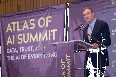 Sen. Mark Warner of Virginia at podium at Atlas of AI Summit