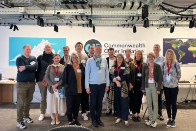 group of people in front of Commonwealth Cyber Initiative sign