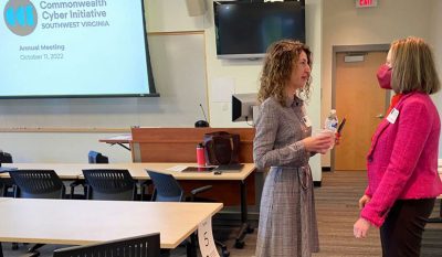 Two women speak in a classroom