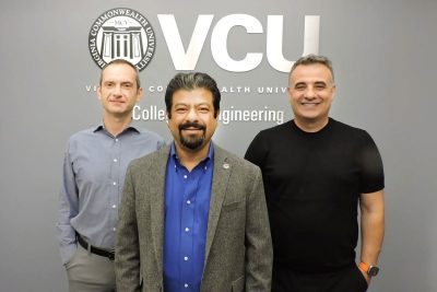 Three men standing in front of VCU College of Engineering sign