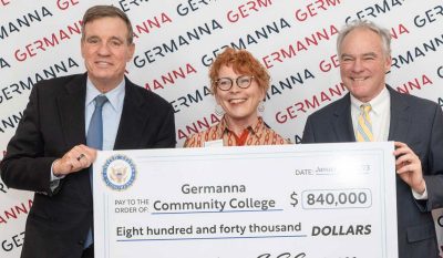 Sen. Mark Warner, left, Germanna President  Janet Gullickson, and Virginia Senator Tim Kaine hold big check for Germanna Community College