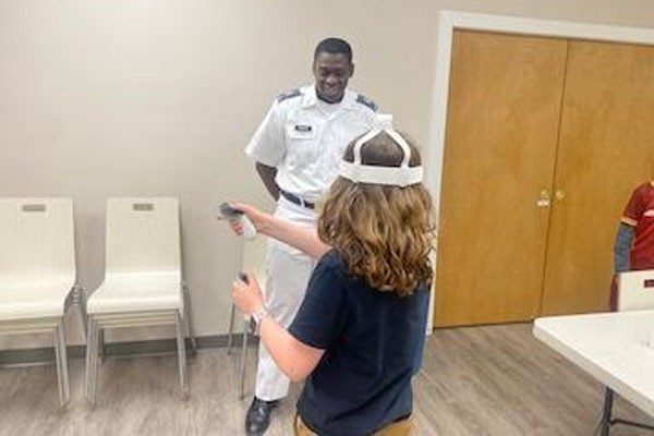 Student wearing virtual reality gear interacts with VMI cadet