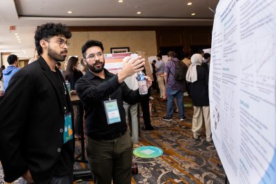 Two people discussing while looking at presentation
