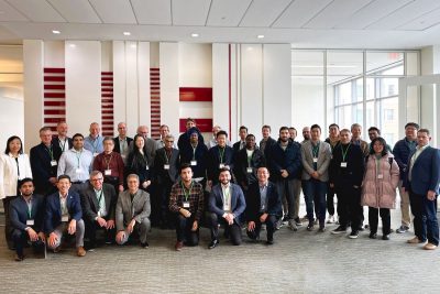 large group of people standing and kneeling in conference room