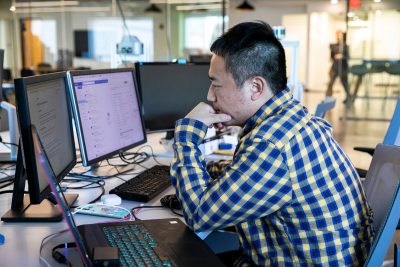 faculty member works on computer in cyber lab