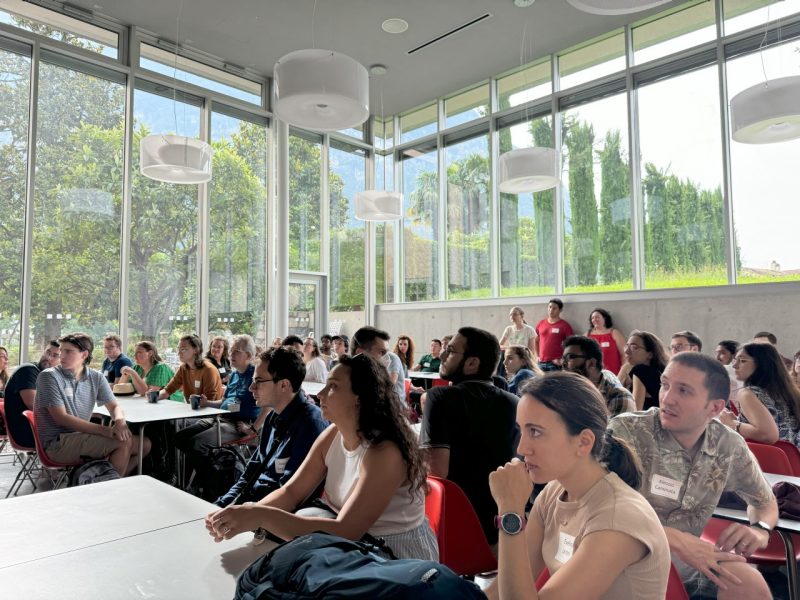 A group of people seated in the Steger Center all looking at an unseen speaker