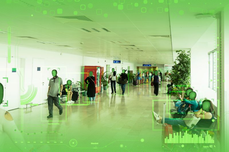 A view of a crowded hallway as seen through a viewer of an augmented reality device.